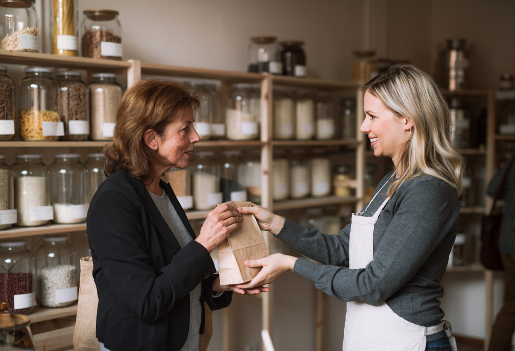 A Female Shop Assistant Serving a Senior Customer in a Zero-Waste Shop.